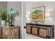 Hallway area with a wooden cabinet, stylish decor, and elegant lighting at 15430 Blackmoor Ter, Lakewood Ranch, FL 34202