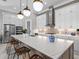Bright kitchen boasts a center island with quartz countertops and seating, plus modern appliances at 15430 Blackmoor Ter, Lakewood Ranch, FL 34202