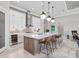 Elegant kitchen features a large island, white cabinets, stainless steel appliances and pendant lighting at 15430 Blackmoor Ter, Lakewood Ranch, FL 34202