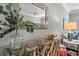 Living room featuring a glass table with a wooden base, a decorative mirror, and a lamp at 15430 Blackmoor Ter, Lakewood Ranch, FL 34202