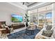 Bright living room with large windows, stylish furniture, and a patterned blue rug at 15430 Blackmoor Ter, Lakewood Ranch, FL 34202
