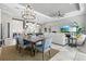 Open concept space with dining area, kitchen, and living room with tile floors and neutral paint at 15430 Blackmoor Ter, Lakewood Ranch, FL 34202