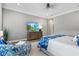 Spacious bedroom suite with TV, seating, and comfortable bed with blue and white linens at 15430 Blackmoor Ter, Lakewood Ranch, FL 34202