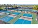 Aerial view of pickleball courts showing well-maintained playing surfaces with nets and benches at 15430 Blackmoor Ter, Lakewood Ranch, FL 34202