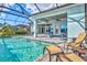 Screened pool with a covered patio and outdoor seating, ideal for relaxing and entertaining at 15430 Blackmoor Ter, Lakewood Ranch, FL 34202