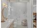 Bright bathroom with glass shower, elegant vanity, and patterned tile floor at 16419 Kendleshire Ter, Lakewood Ranch, FL 34202