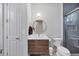 Bathroom features a wood vanity, modern fixtures, and separate toilet area at 16419 Kendleshire Ter, Lakewood Ranch, FL 34202