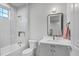 Clean bathroom featuring a shower-tub combo, sleek vanity, and modern fixtures at 16419 Kendleshire Ter, Lakewood Ranch, FL 34202