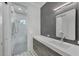 This bathroom features a modern vanity, striking tile work, and a glass-enclosed shower at 16419 Kendleshire Ter, Lakewood Ranch, FL 34202