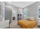 Cozy bedroom with a bright yellow comforter, side table, and connecting bathroom at 16419 Kendleshire Ter, Lakewood Ranch, FL 34202