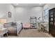 Bright bedroom with a small twin bed, pink chair, desk, and shelving space at 16419 Kendleshire Ter, Lakewood Ranch, FL 34202