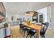 Bright dining room with modern lighting fixture flows seamlessly into the open kitchen and living areas at 16419 Kendleshire Ter, Lakewood Ranch, FL 34202
