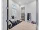 Bright workout room with modern equipment, shelving, and a full-length mirror at 16419 Kendleshire Ter, Lakewood Ranch, FL 34202