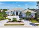Stunning one-story home with a manicured lawn, circular driveway, and striking black double-door entrance at 16419 Kendleshire Ter, Lakewood Ranch, FL 34202