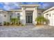 Close up of the front entrance with statement double doors and manicured landscaping at 16419 Kendleshire Ter, Lakewood Ranch, FL 34202