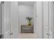 Hallway showcasing a wooden console table with a decorative vase and book, creating a welcoming atmosphere at 16419 Kendleshire Ter, Lakewood Ranch, FL 34202