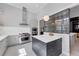 Well-lit kitchen with modern appliances, an island, and stylish patterned flooring at 16419 Kendleshire Ter, Lakewood Ranch, FL 34202