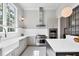 Modern kitchen boasts stainless steel appliances, custom cabinets, quartz countertops, and a designer tile floor at 16419 Kendleshire Ter, Lakewood Ranch, FL 34202