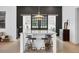 Spacious kitchen featuring a large island with bar seating and modern pendant lighting at 16419 Kendleshire Ter, Lakewood Ranch, FL 34202