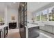 Charming kitchen featuring a large window, an island with bar seating, and modern fixtures at 16419 Kendleshire Ter, Lakewood Ranch, FL 34202