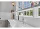 Close-up of kitchen sink with stylish faucet, countertop, and natural light from window at 16419 Kendleshire Ter, Lakewood Ranch, FL 34202
