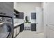 Laundry room boasts modern machines, storage, folding counter, and sink at 16419 Kendleshire Ter, Lakewood Ranch, FL 34202