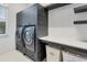 This laundry room features front loading machines, ample storage, and a folding counter at 16419 Kendleshire Ter, Lakewood Ranch, FL 34202