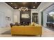 Bright living room features a wood-paneled ceiling, sleek fireplace, and custom wine storage at 16419 Kendleshire Ter, Lakewood Ranch, FL 34202