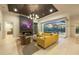 Elegant living room featuring a fireplace, modern furniture, and a view of the outdoor pool at 16419 Kendleshire Ter, Lakewood Ranch, FL 34202