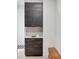 Mud room with dark cabinets, light subway tile backsplash, and a white countertop at 16419 Kendleshire Ter, Lakewood Ranch, FL 34202