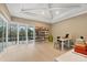 Well-lit office featuring a wall of floor to ceiling glass doors and a bookshelf at 16419 Kendleshire Ter, Lakewood Ranch, FL 34202