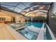 A screened-in pool and spa offer a tranquil retreat, enhanced by stunning sunset views at 16419 Kendleshire Ter, Lakewood Ranch, FL 34202