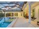 A covered patio extends to a spacious pool and spa, perfect for entertaining and relaxing outdoors at 16419 Kendleshire Ter, Lakewood Ranch, FL 34202