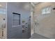 This shower features elegant tilework, a recessed shelf, and modern fixtures at 16419 Kendleshire Ter, Lakewood Ranch, FL 34202
