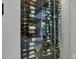 Custom built-in glass wine storage unit showcasing the home's luxurious amenities at 16419 Kendleshire Ter, Lakewood Ranch, FL 34202