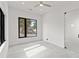 Minimalist bedroom with gray floors, recessed lighting, and modern black-framed windows at 1716 9Th St, Sarasota, FL 34236