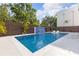 Sparkling blue in-ground pool with a water feature, set amidst lush landscaping at 1716 9Th St, Sarasota, FL 34236