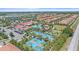 An aerial view showcasing the community's homes, clubhouse, pool, tennis courts, and scenic lake at 17216 Star Banks St, Wimauma, FL 33598