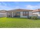 Well-maintained backyard with green lawn and a covered patio perfect for outdoor living at 17216 Star Banks St, Wimauma, FL 33598