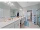 Bathroom featuring double sinks, a large mirror, and views into the walk-in closet and shower at 17216 Star Banks St, Wimauma, FL 33598