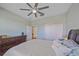 Bright bedroom featuring a ceiling fan, closet, and view into another room at 17216 Star Banks St, Wimauma, FL 33598