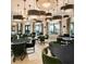 The clubhouse interior features modern lighting, tables, chairs and an open space to gather at 17216 Star Banks St, Wimauma, FL 33598