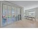 Bright dining room with tile floors, shuttered sliding glass doors, and a dining set at 17216 Star Banks St, Wimauma, FL 33598