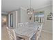 Dining room features an updated chandelier, neutral colors and an open floor plan at 17216 Star Banks St, Wimauma, FL 33598