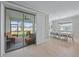 Bright dining room with tile floors and large sliding glass doors out to screened patio at 17216 Star Banks St, Wimauma, FL 33598