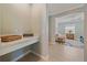 Hallway leading into living room with light tiled floors and view of seating area at 17216 Star Banks St, Wimauma, FL 33598