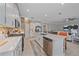 Open concept kitchen features a large island, stainless steel appliances and stone countertops at 17216 Star Banks St, Wimauma, FL 33598