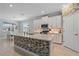Modern kitchen with an island, white cabinets, stainless steel appliances and tile backsplash at 17216 Star Banks St, Wimauma, FL 33598