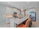 Kitchen features stainless steel appliances, white cabinets, stone countertops and a large island at 17216 Star Banks St, Wimauma, FL 33598