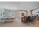 Modern kitchen features stainless steel appliances, white cabinets, tile backsplash and an eat-in table at 17216 Star Banks St, Wimauma, FL 33598